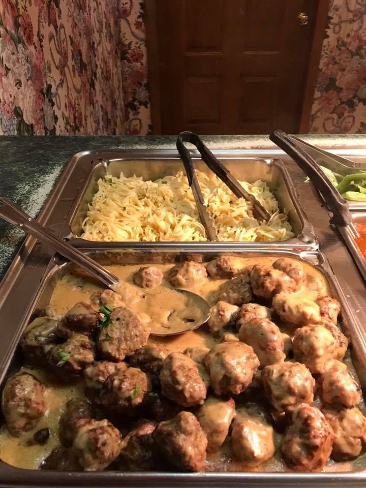 Meatballs in gravy and buttered noodles on the buffet